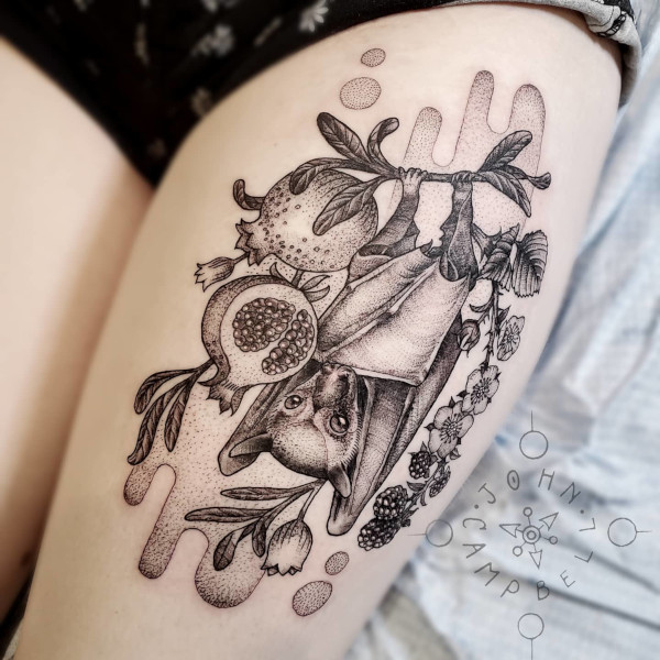 Realistic bat hanging from pomegranate with brambles dotwork tattoo. Book a custom tattoo with John at Sacred Mandala Studio - Durham, NC.